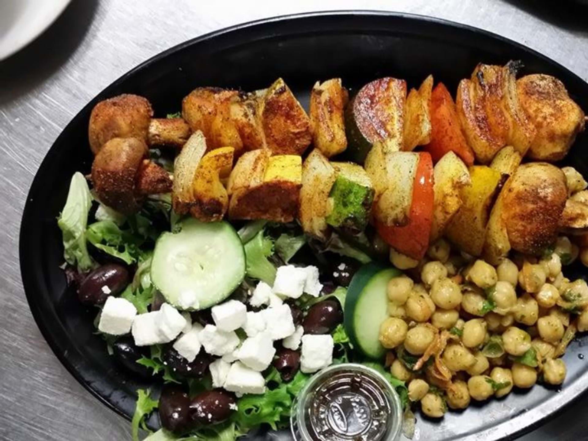 Kebab Plate with grilled vegetables Chickpea Salad and Greek Salad