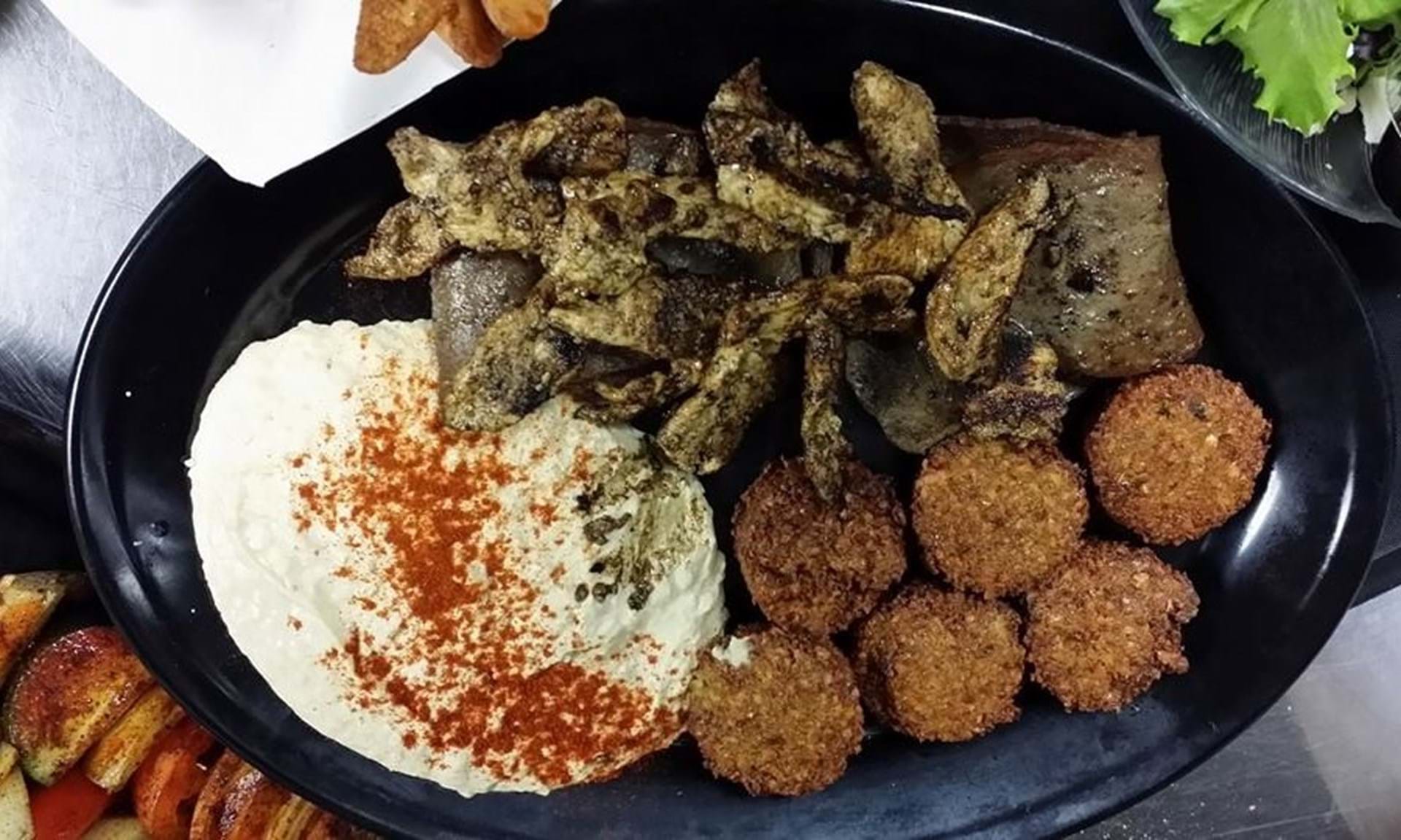 Kebab Plate with gyro and chicken shawarma meats and hummus and falafel balls. 
