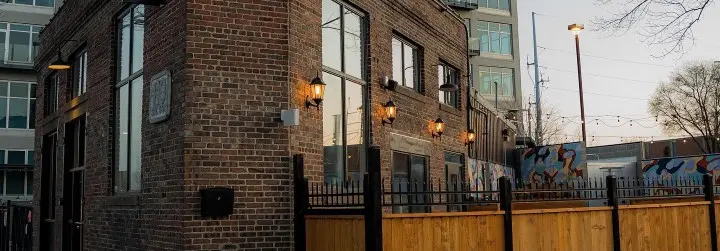 The brick exterior of a historic depot and its patio. 