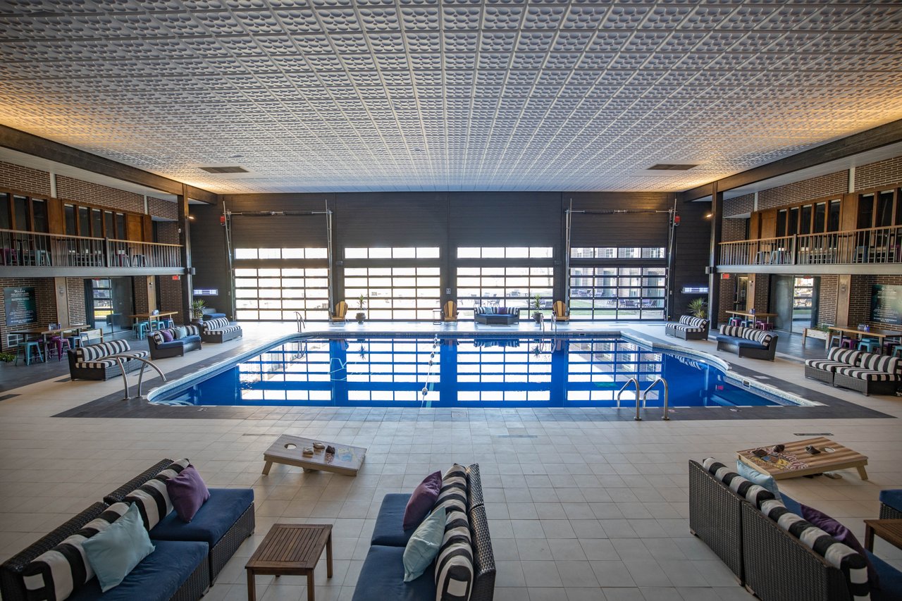The indoor pool at the Highlander Hotel boast high ceilings and glass garage doors that open to the courtyard.