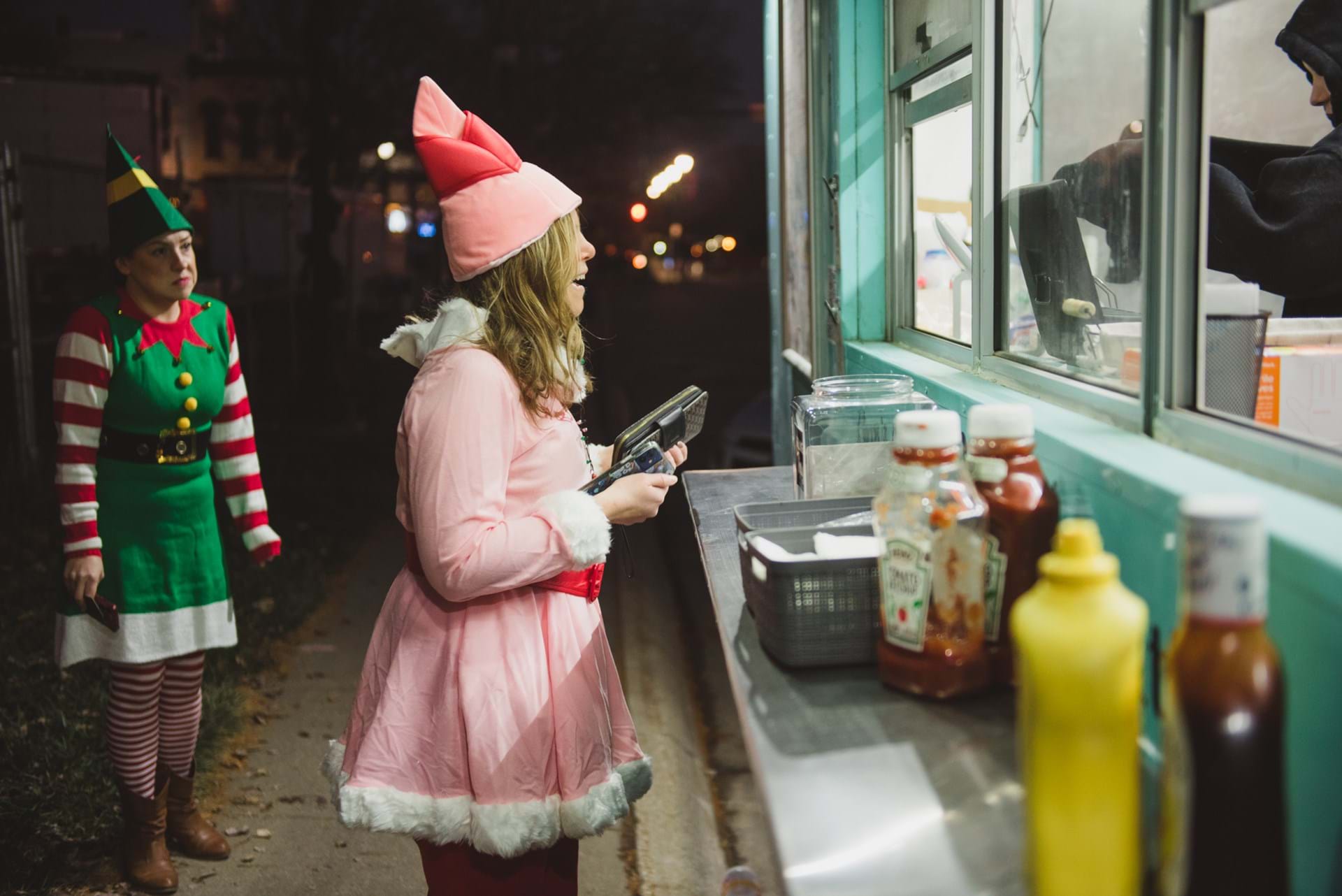 Elves grab a bite from a food vendor at the Winterset Festival of Lights