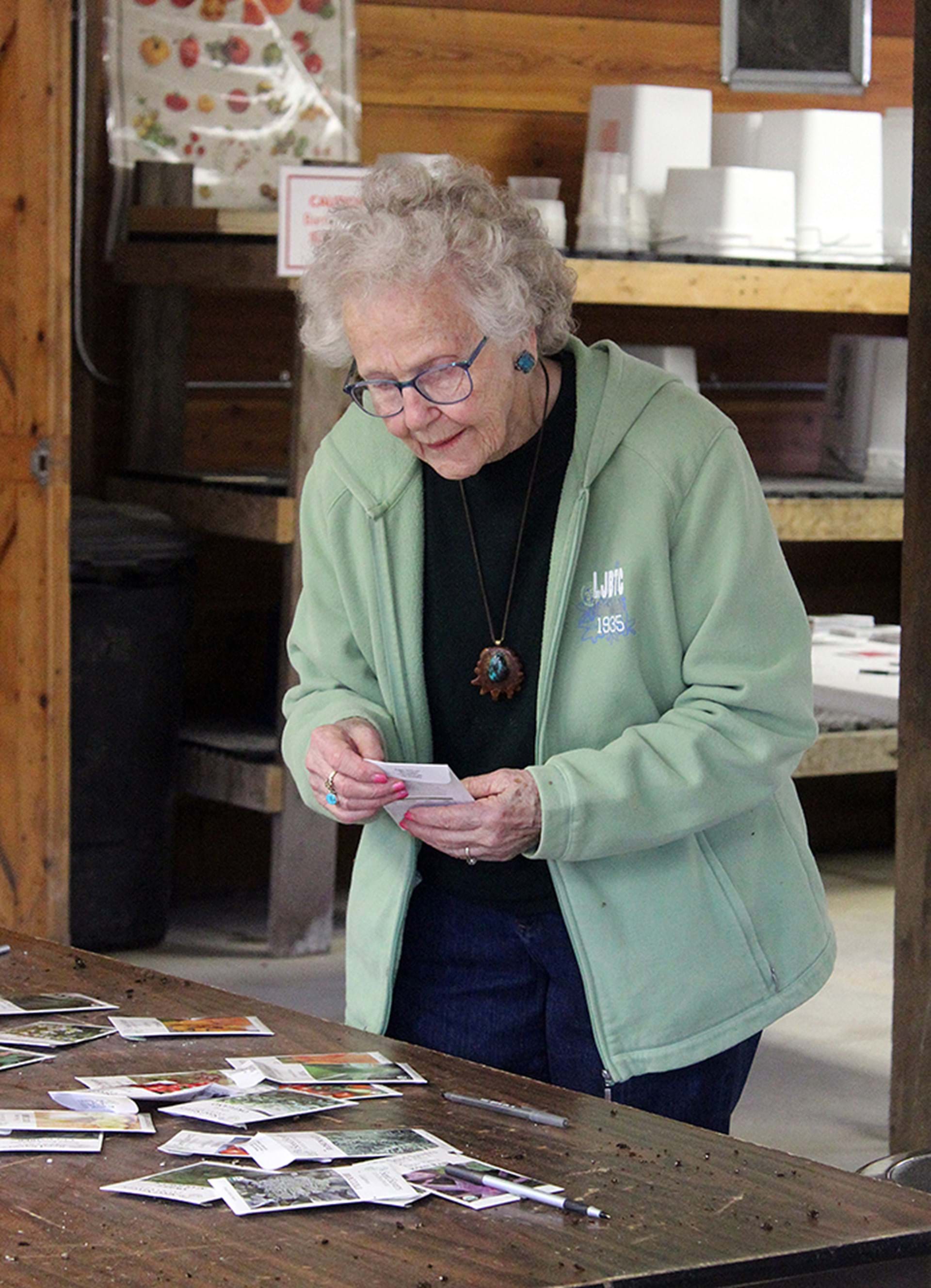 Workshop attendee looks over seed selections.