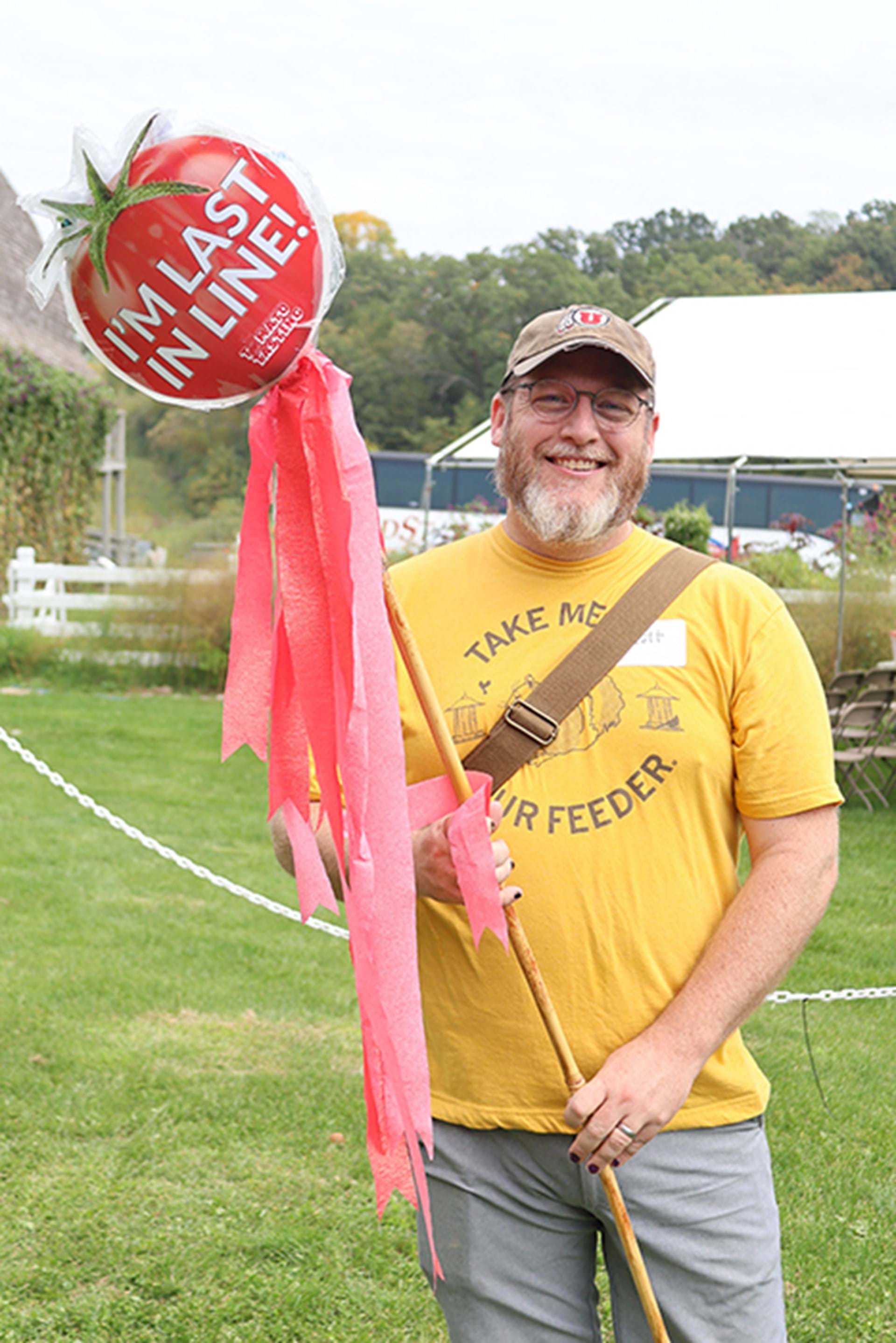 Tomato tasting participant proudly stands as the last in line.
