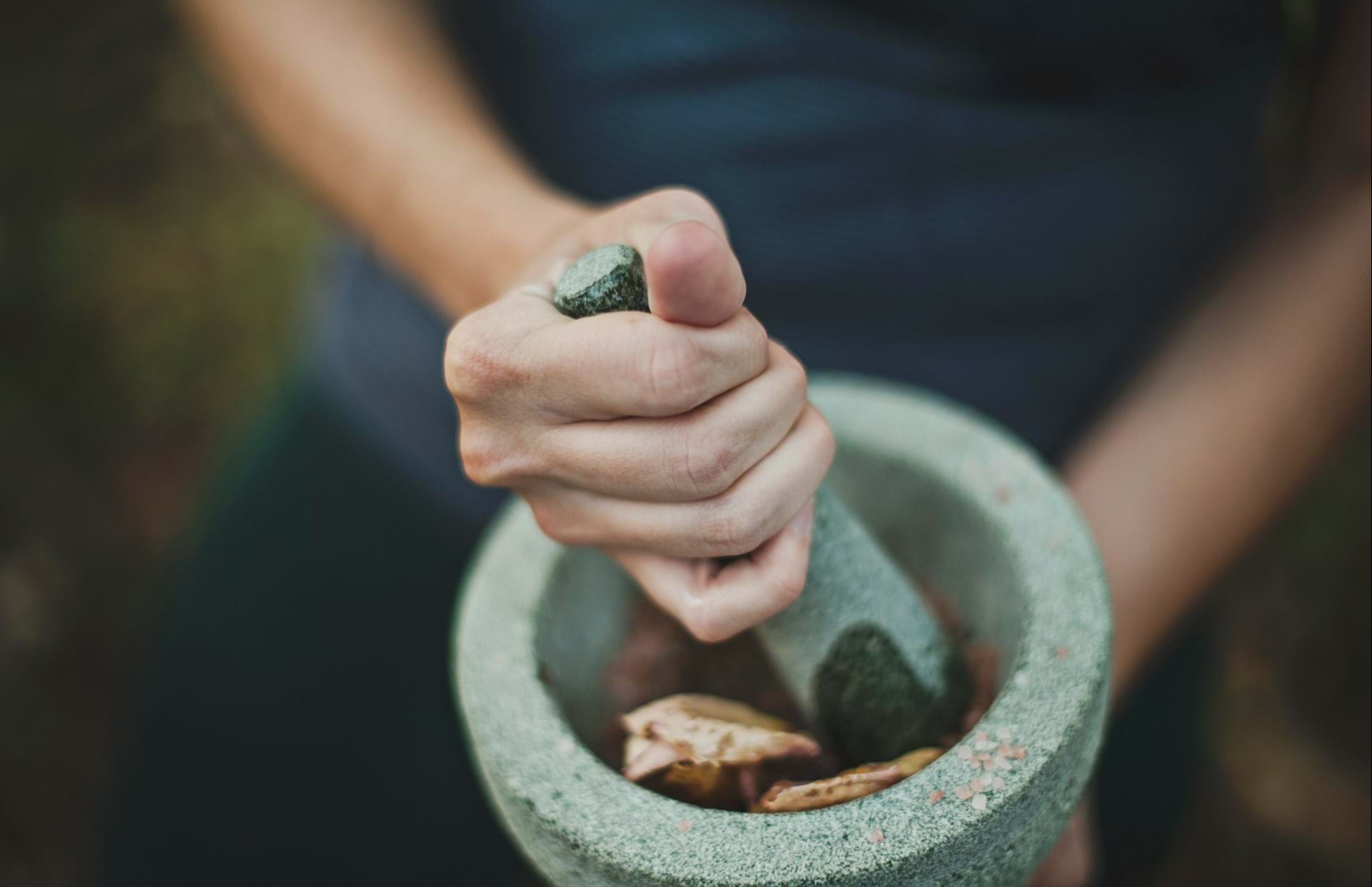 Grinding stone into pigment by hand.