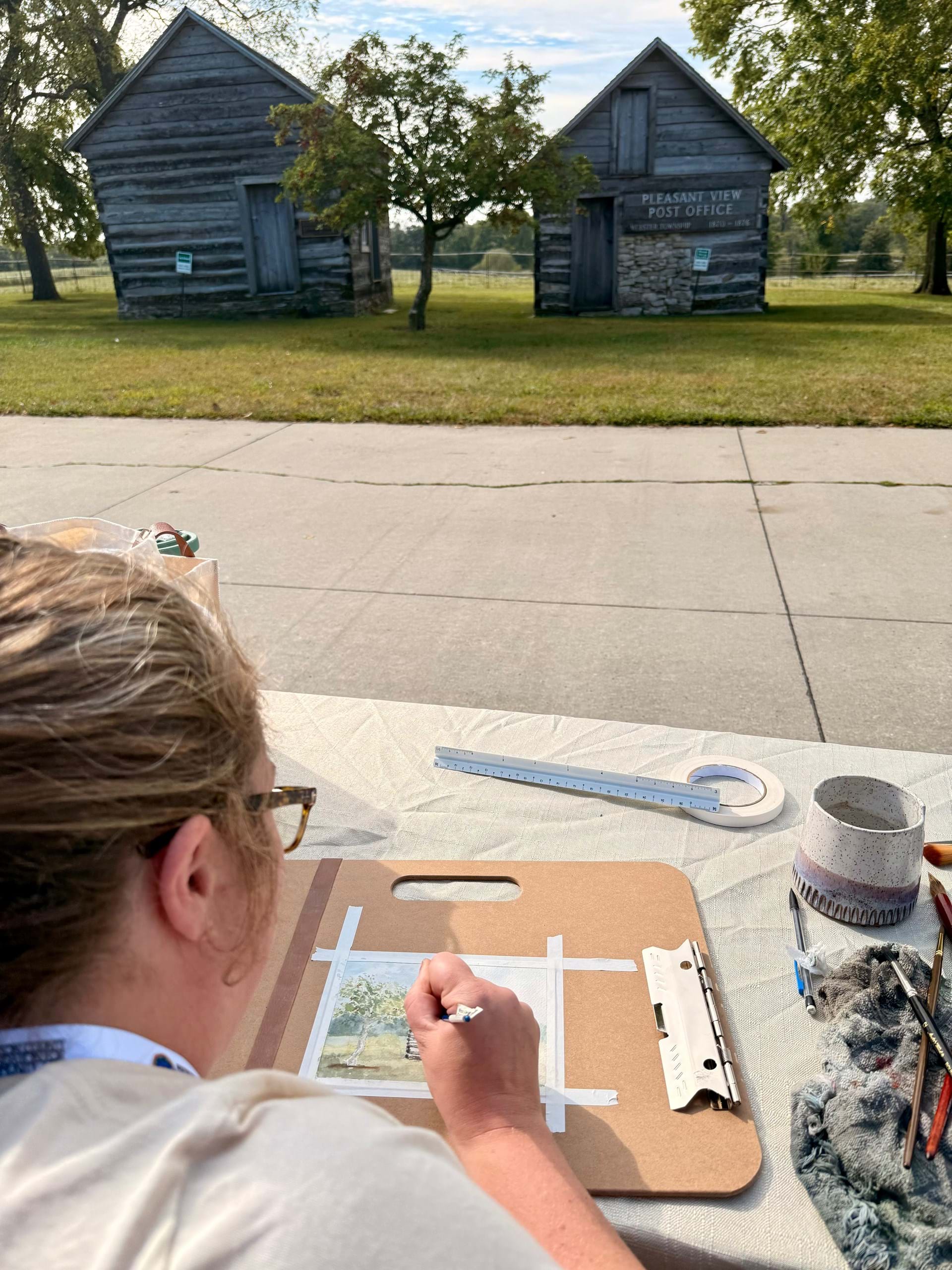 An artist paints at the Madison County Historical Complex in Winterset