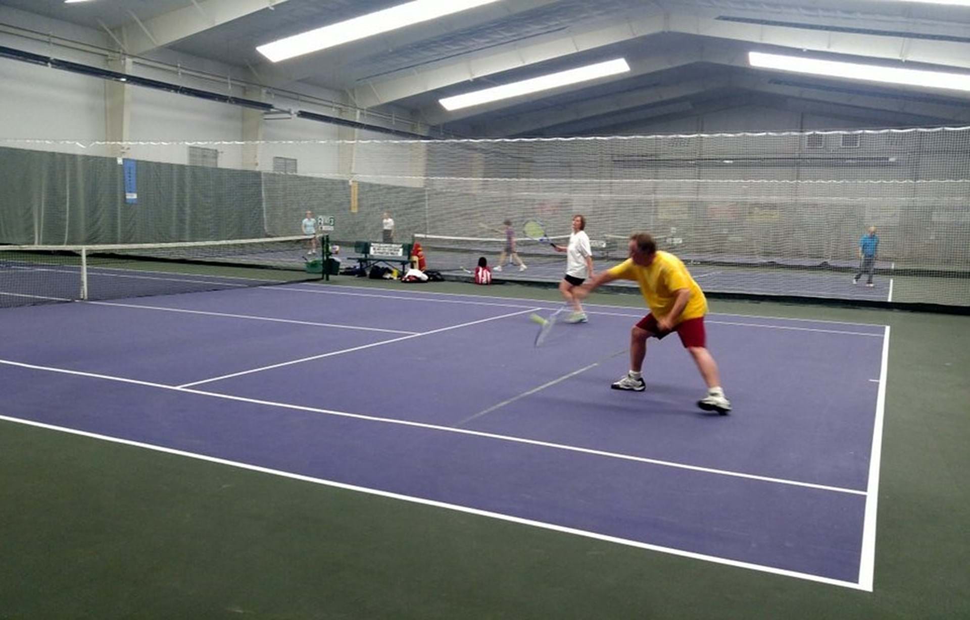 Saturday morning tennis players Kevin Lingren (in yellow) of Malvern, IA and Jan Torok (in white) of Council Bluffs, IA.