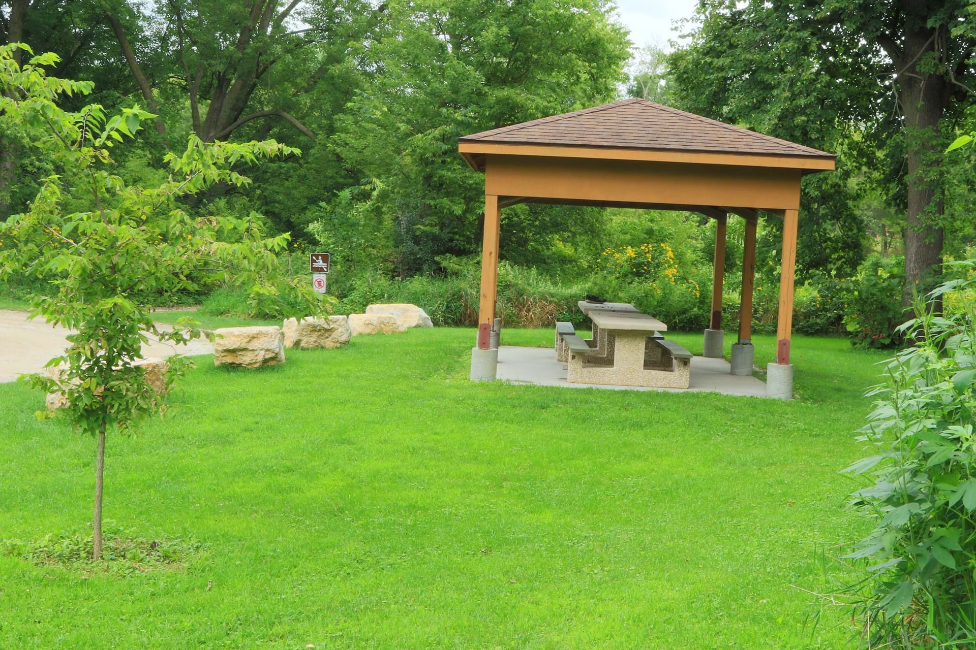 A shelter with a picnic table at the park
