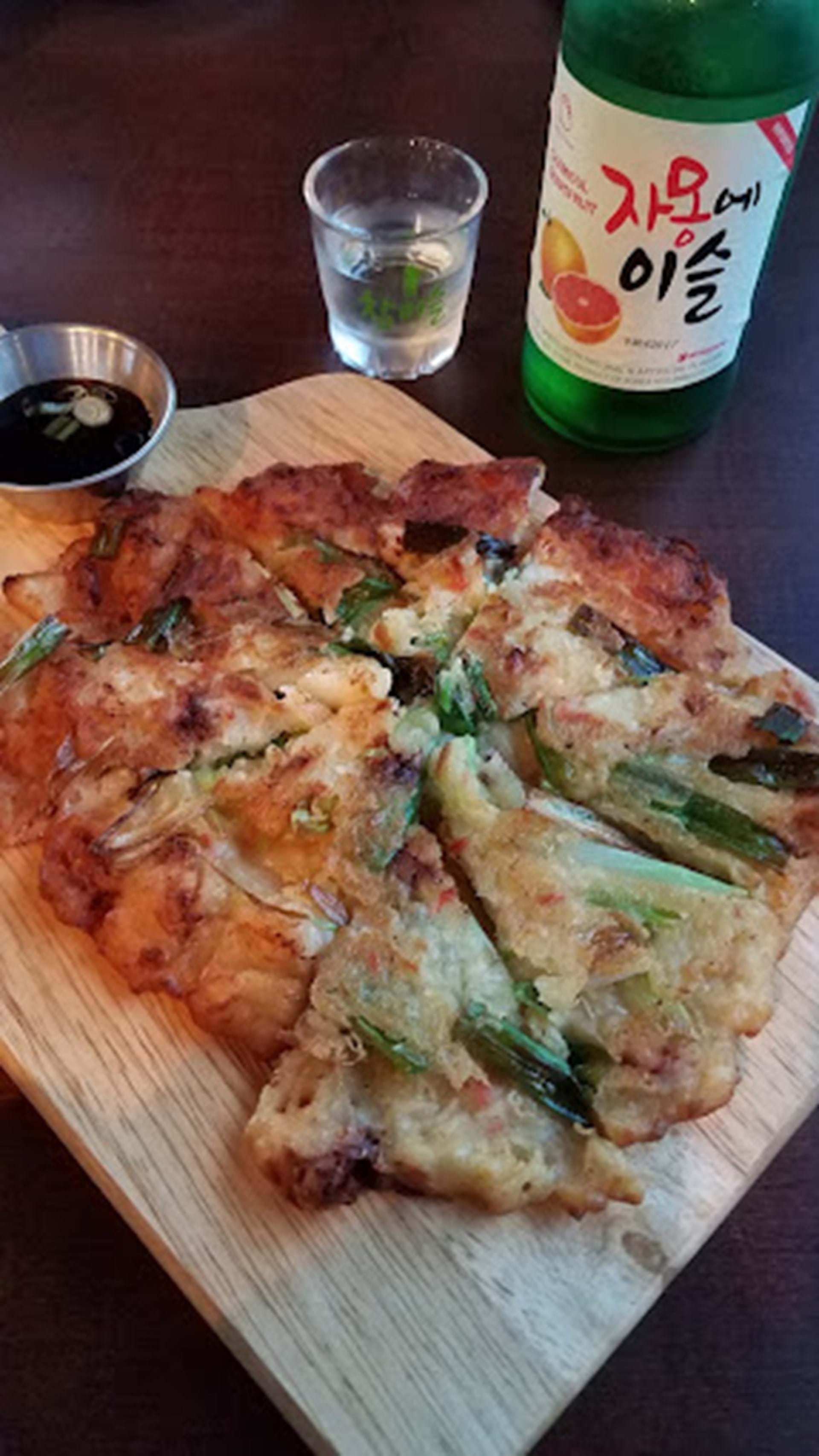 The crab-scallion pancake with a house-made sauce and cool alcoholic beverage is the Korean spin on bar food.