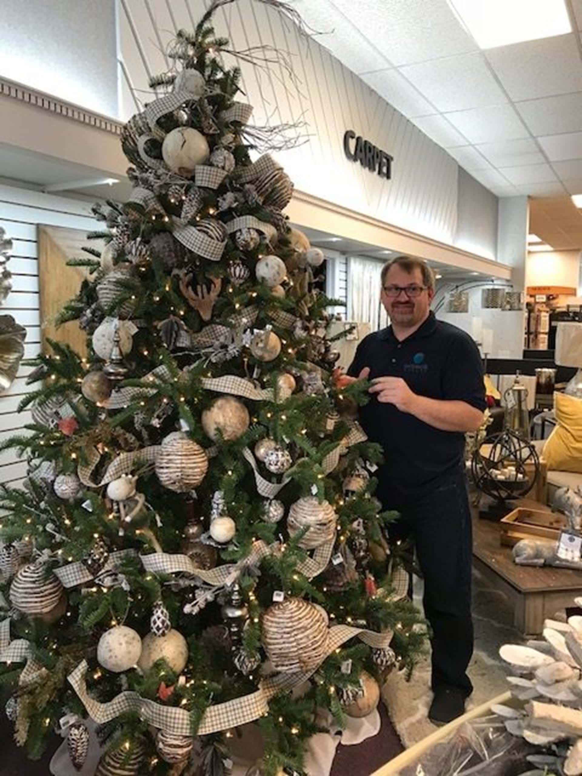 Kevin Rubash, owner, stands with a holiday tree in preparation of the holiday season. 