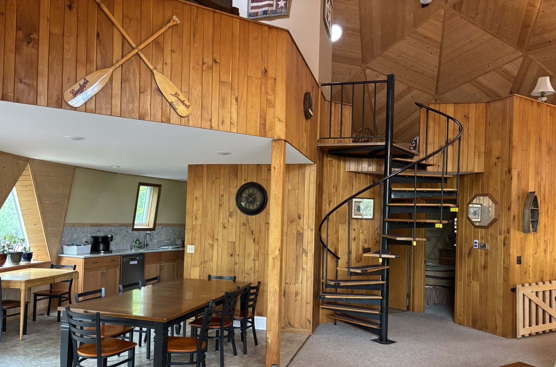 Spacious living/dining area with spiral staircase to upstairs bedroom loft
