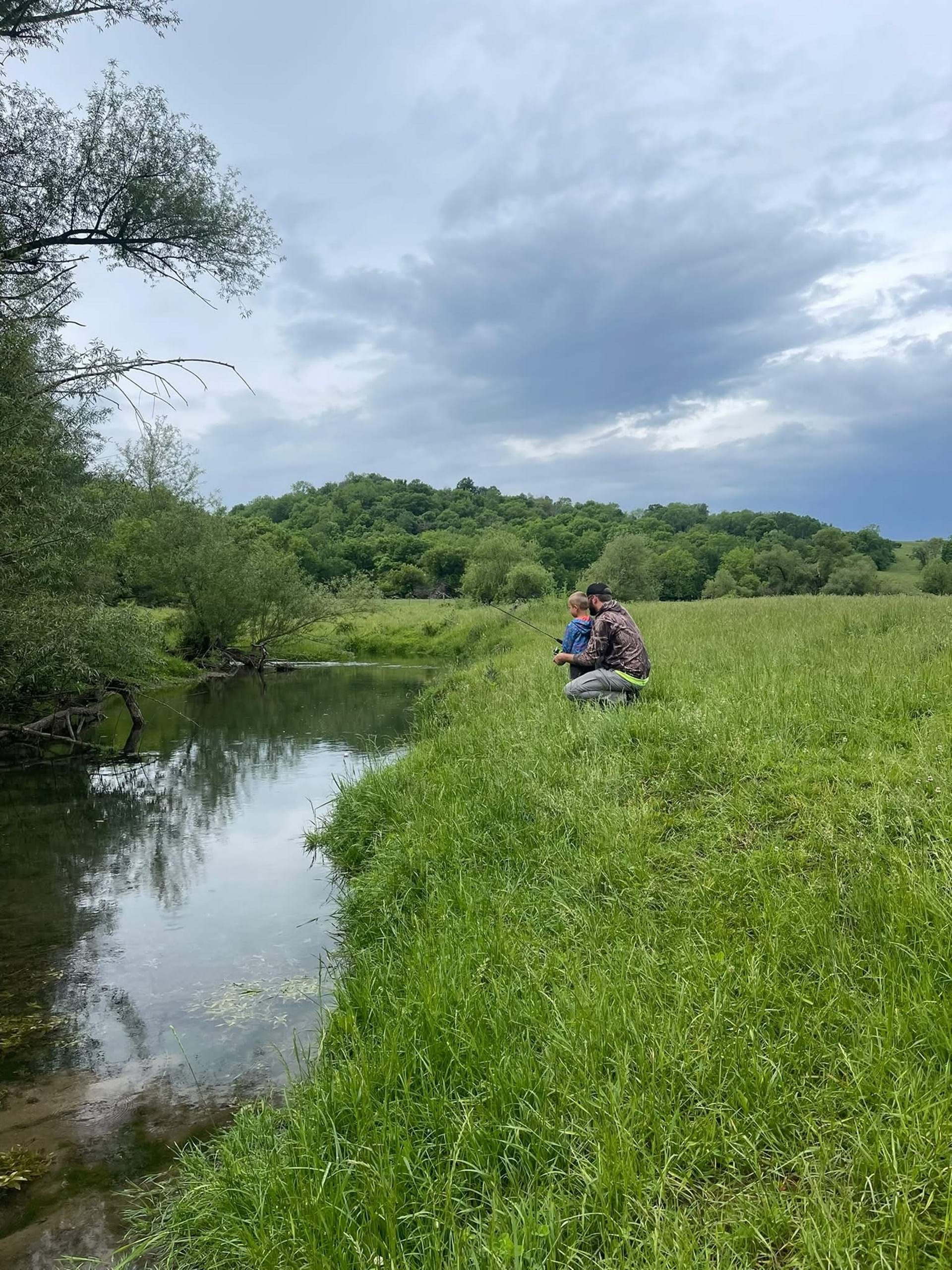 A quiet family fishing moment along Waterloo Creek at Waterloo Hollow in Iowa's Driftless region