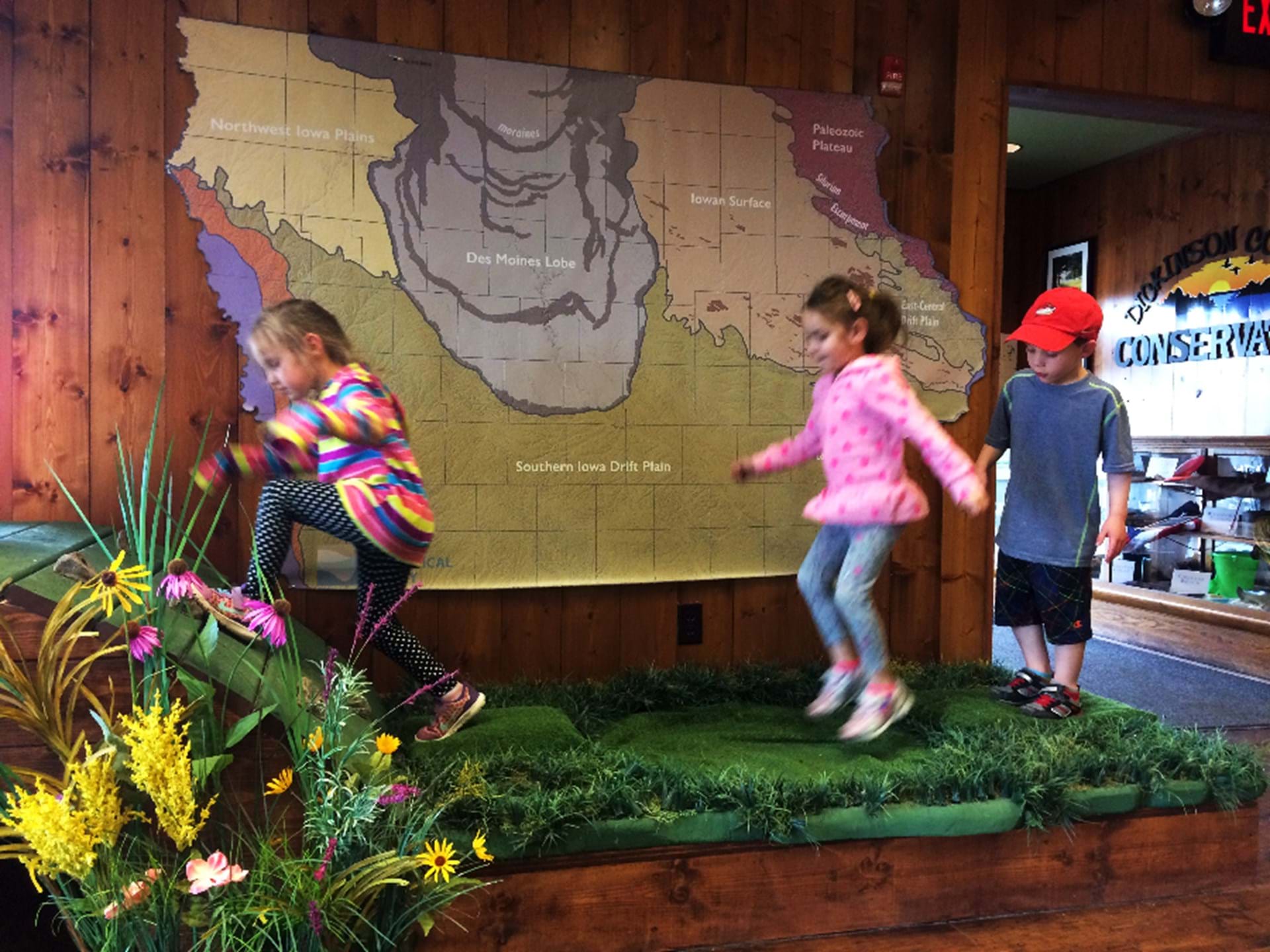 Interact with exhibits, like jumping on a fen or climbing a glacial kame in the glacial landmark tour area.